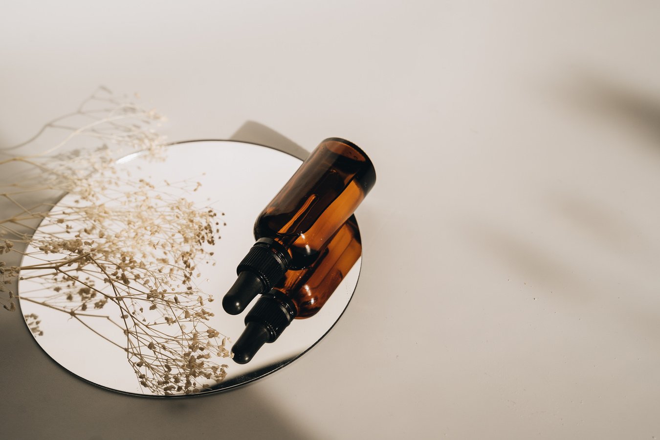 Brown Serum Bottle on a Round Mirror